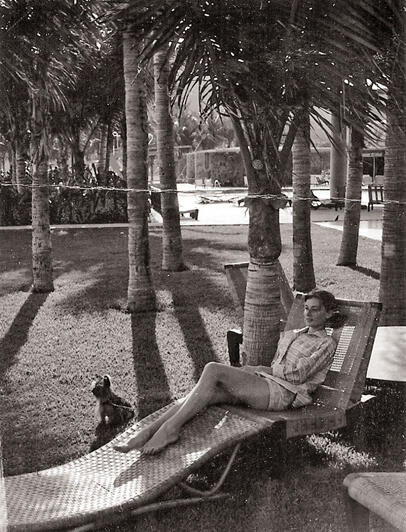 In 1957, Audrey with her beloved Yorkie, Mr. Famous, relaxing at Connie Wald's home. Photo by Andrew Wald.
