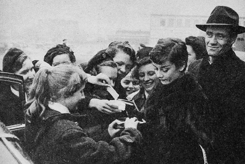 Audrey signing autographs in Paris, 1955.